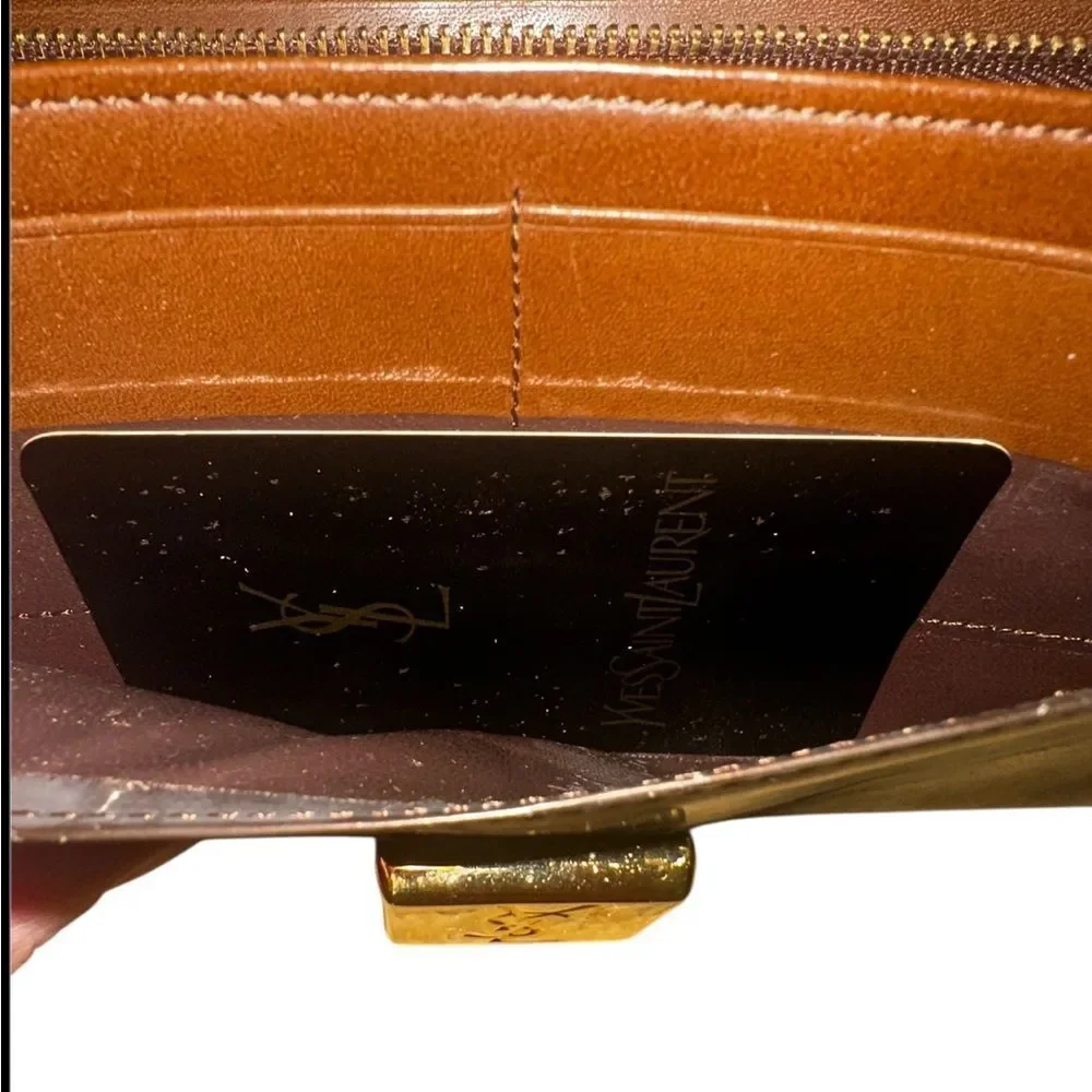 Yves Saint Laurent Tan Leather Wallet with Gold Clasp with marks and scratches.